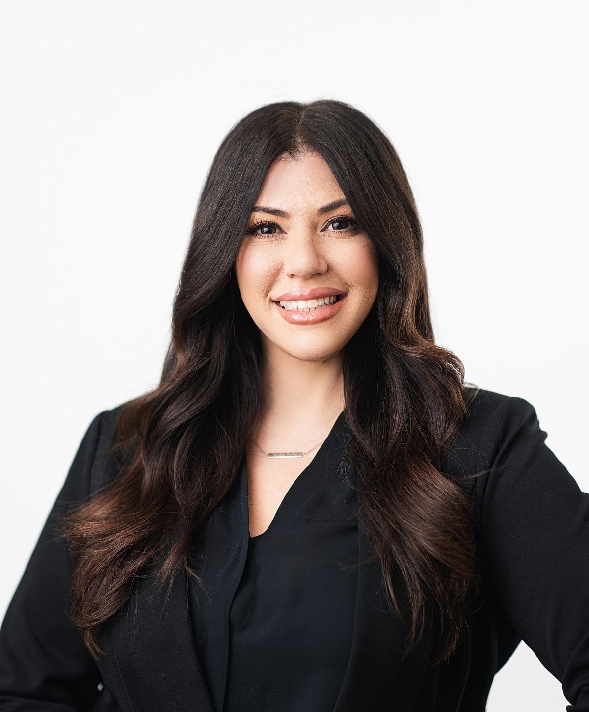 Professional woman smiling in a black blazer.