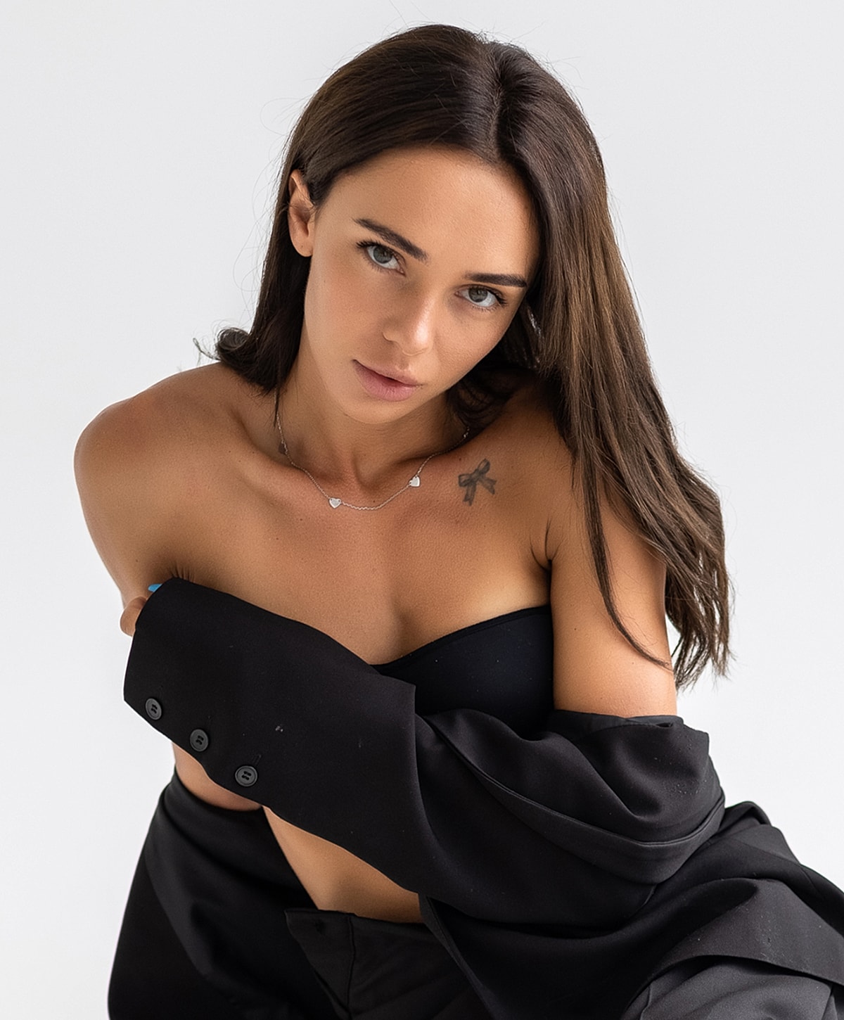 Model in black outfit with natural makeup.