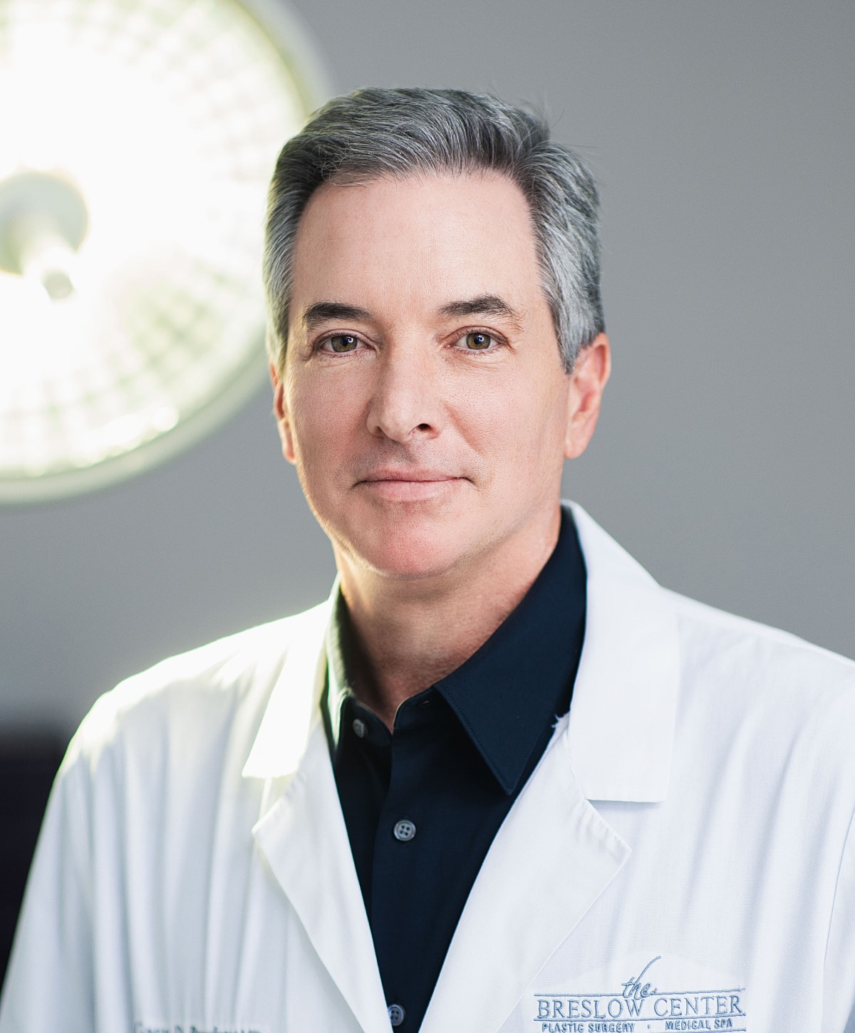 Male doctor in a medical setting, wearing lab coat.
