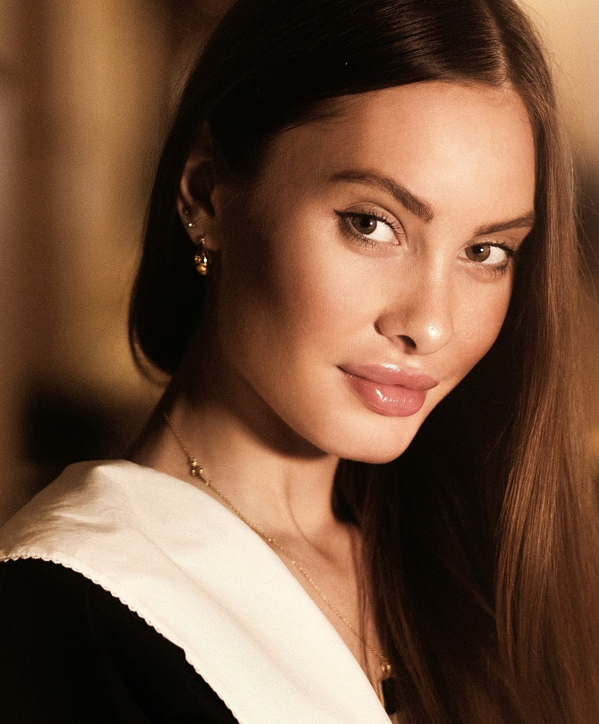 Woman with long hair and elegant jewelry.