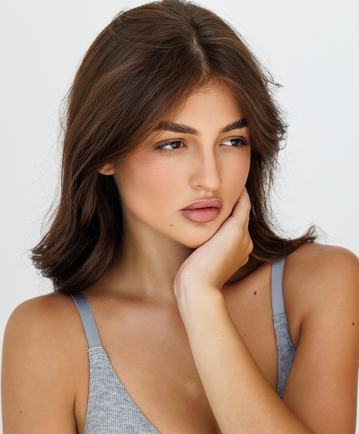 Model with soft expression and natural makeup.