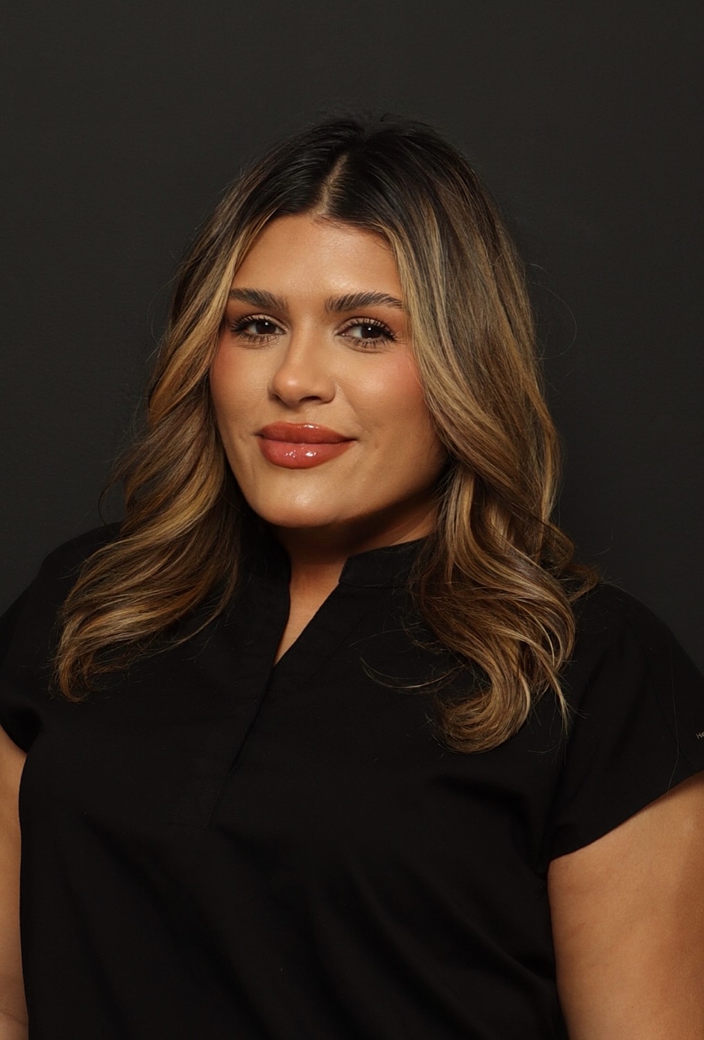 Woman with wavy hair in black shirt.