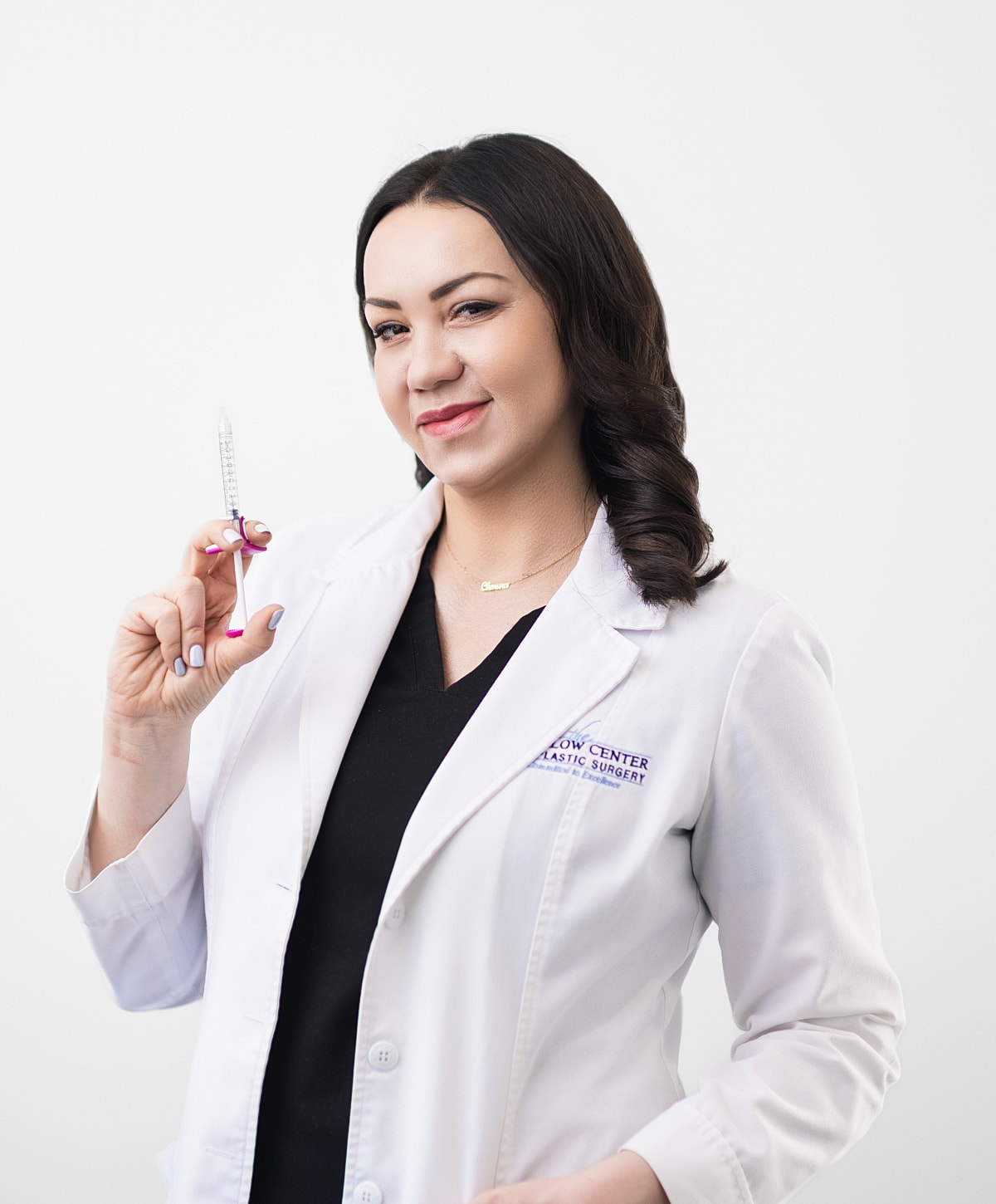 Medical professional holding syringe in lab coat.