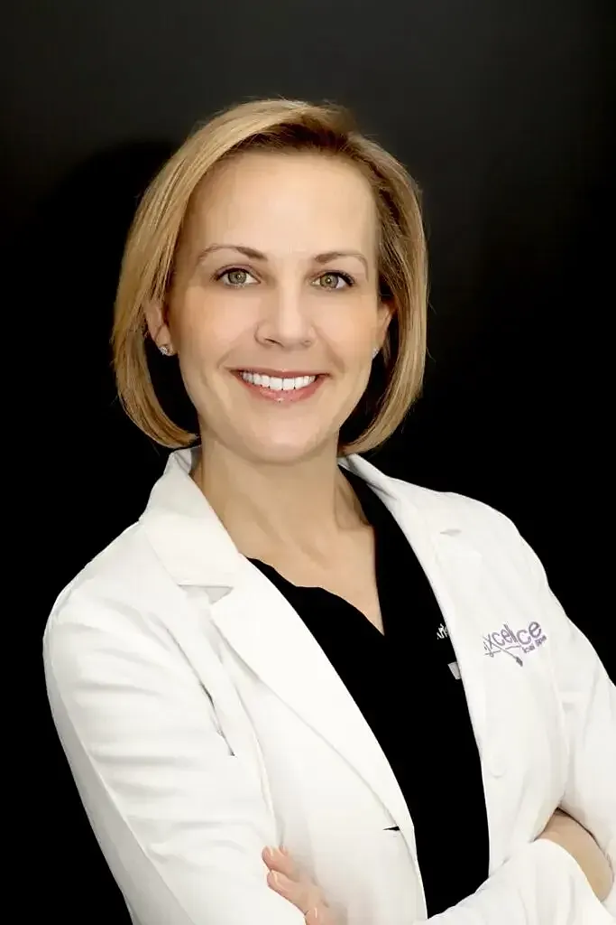 Smiling doctor in a white coat with arms crossed