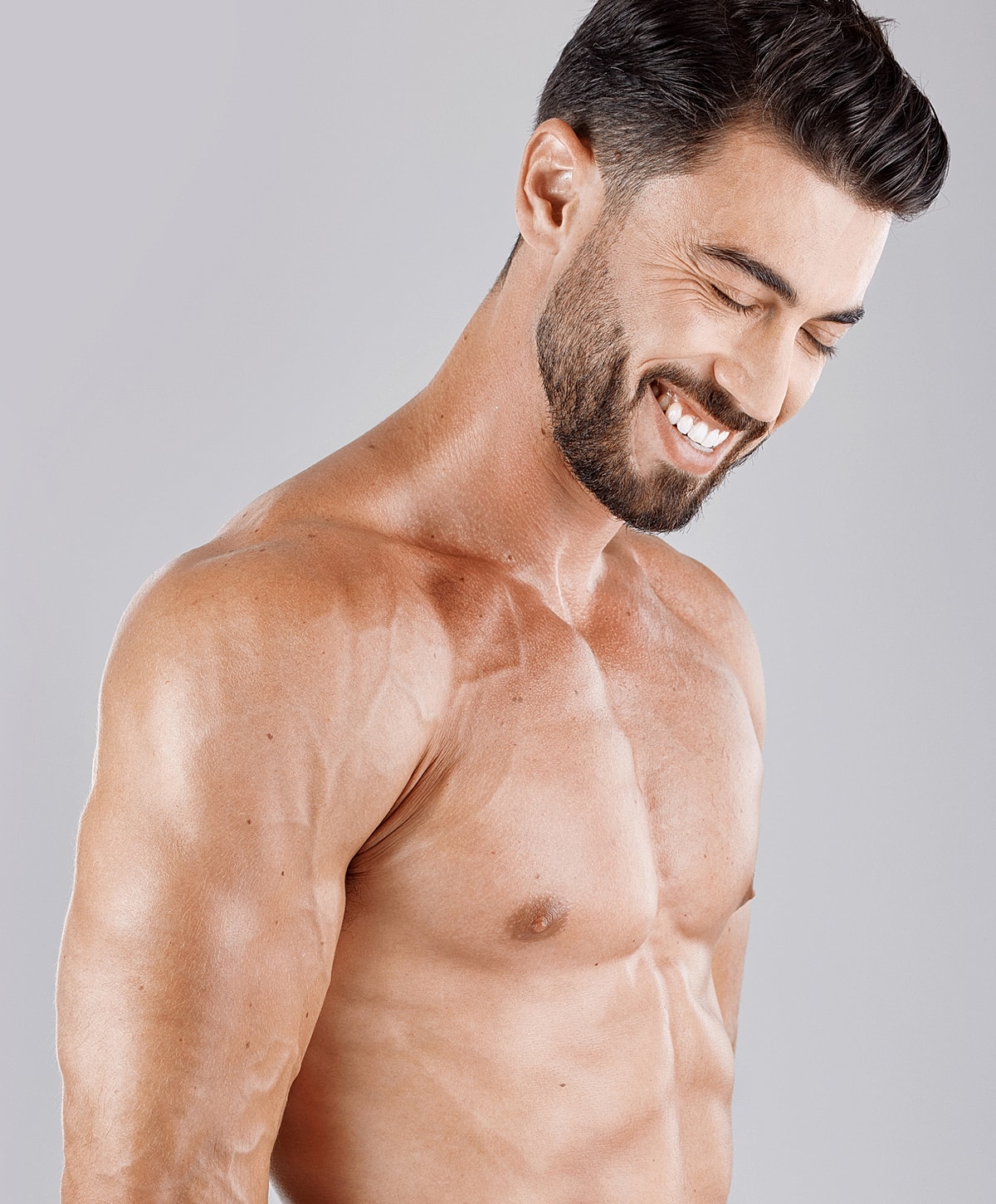 Smiling man with athletic build and toned physique.