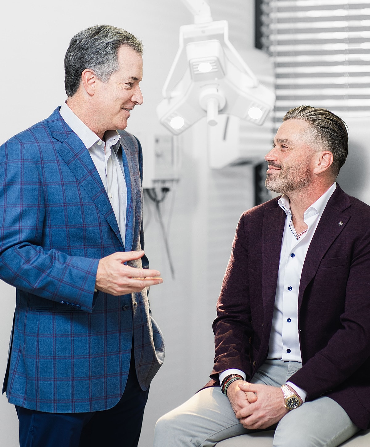 Two men conversing in a professional setting.