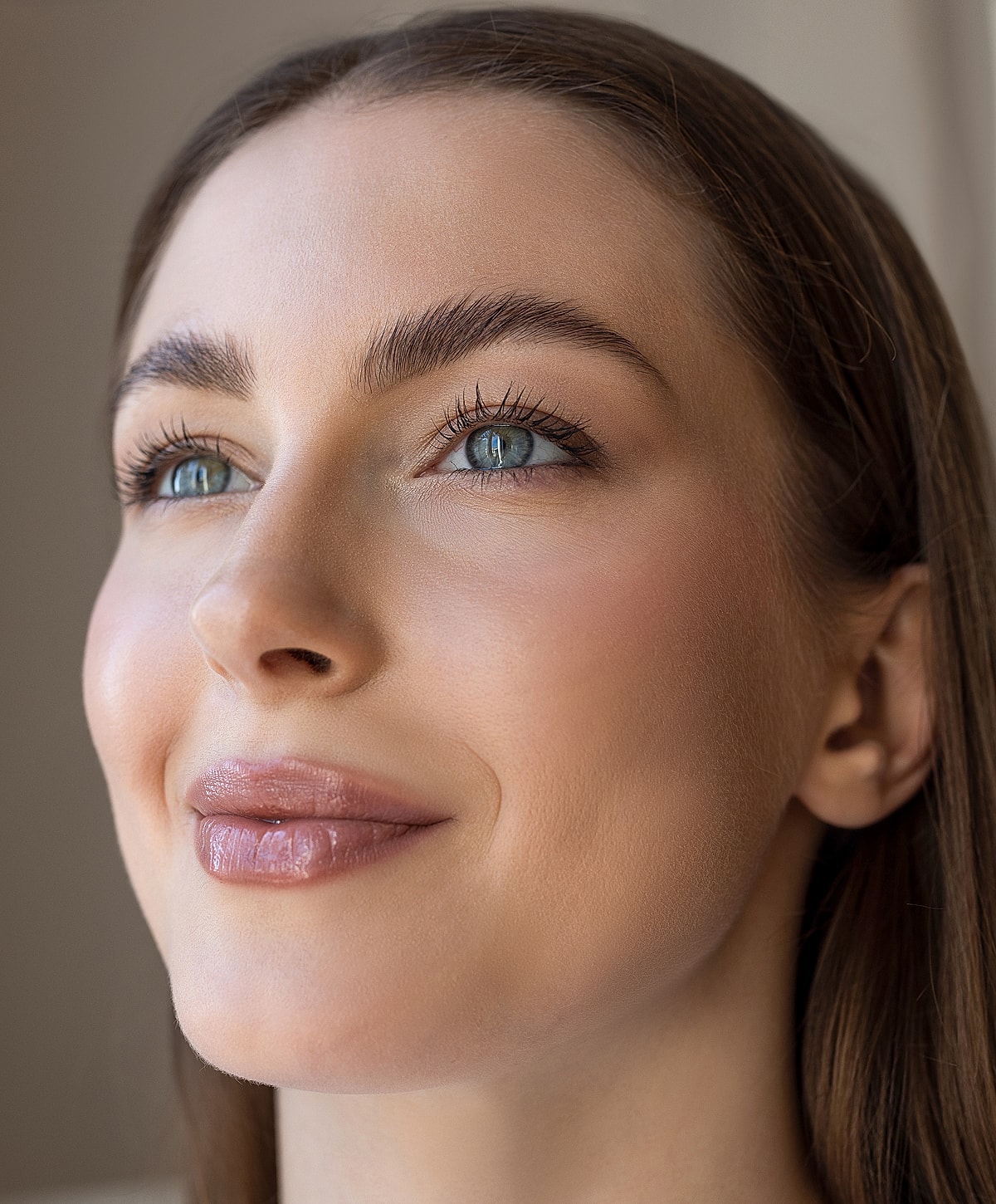 Close-up of a woman with glowing skin.