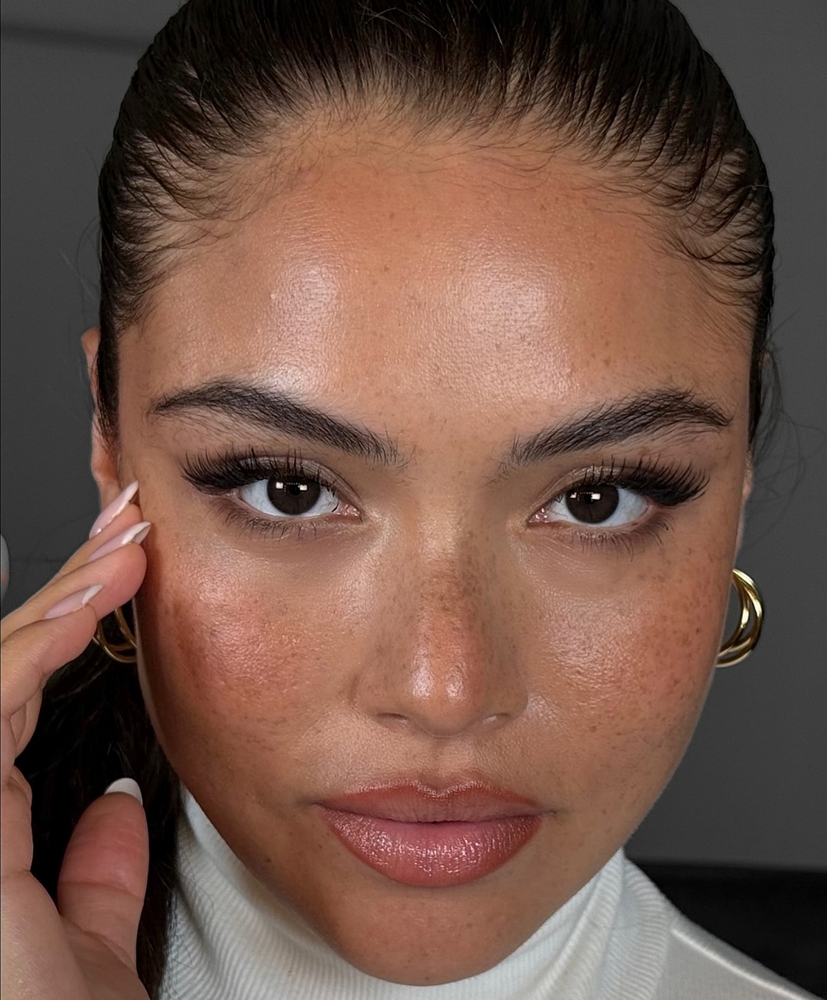 Close-up portrait of a person with flawless skin.