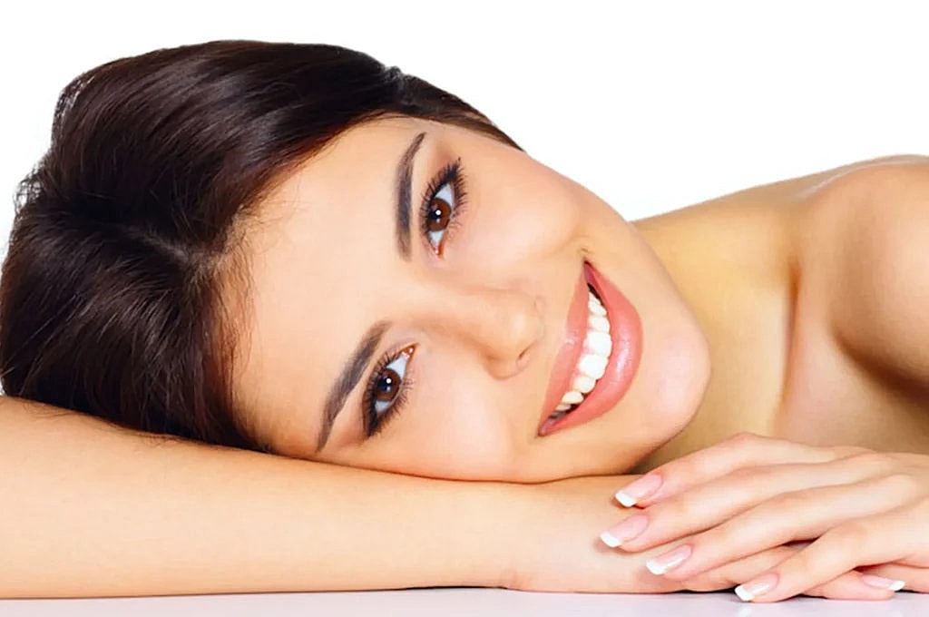 Smiling woman with beautiful skin and hair.