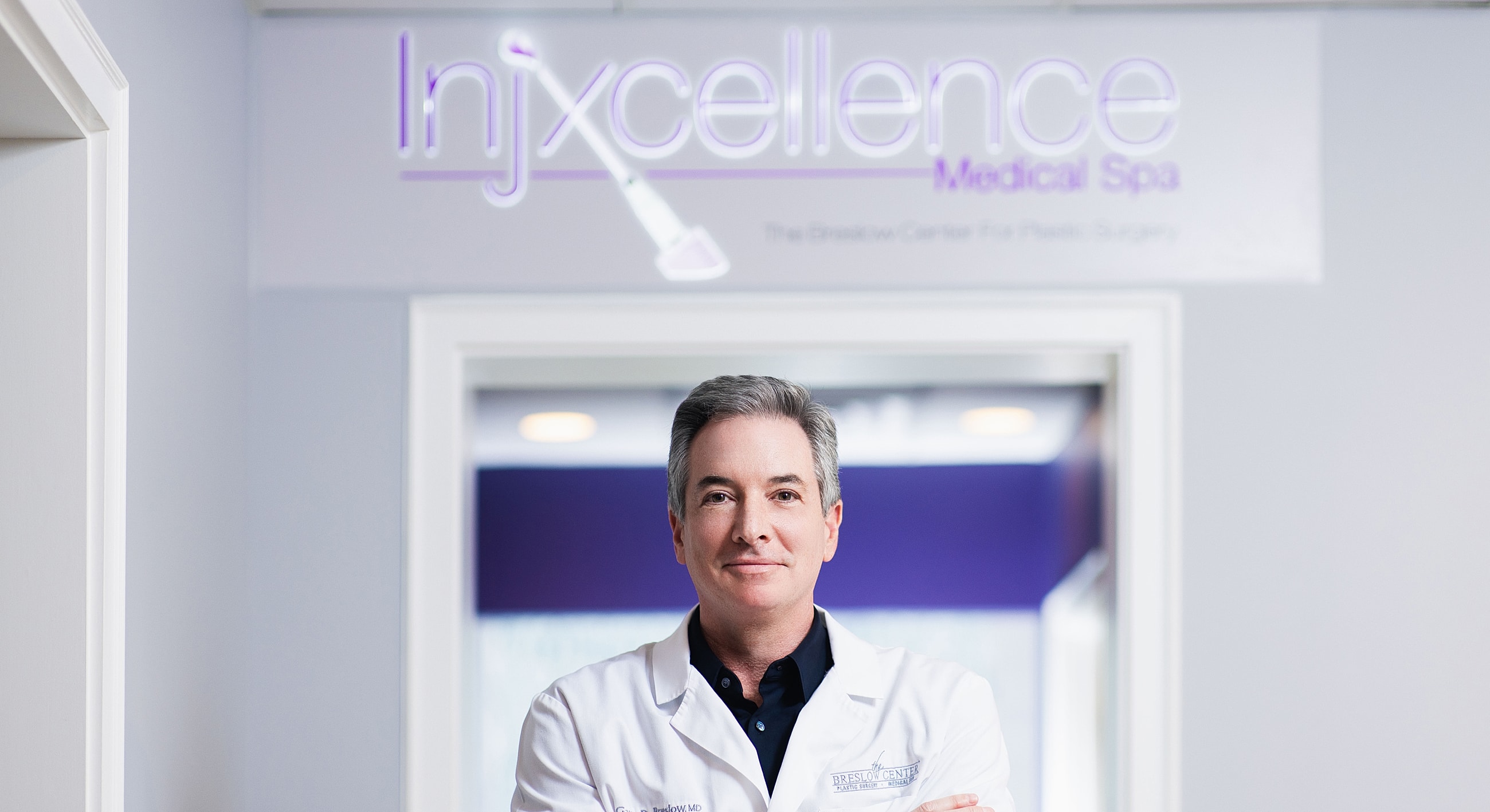 Doctor at Injxcellence Medical Spa entrance.