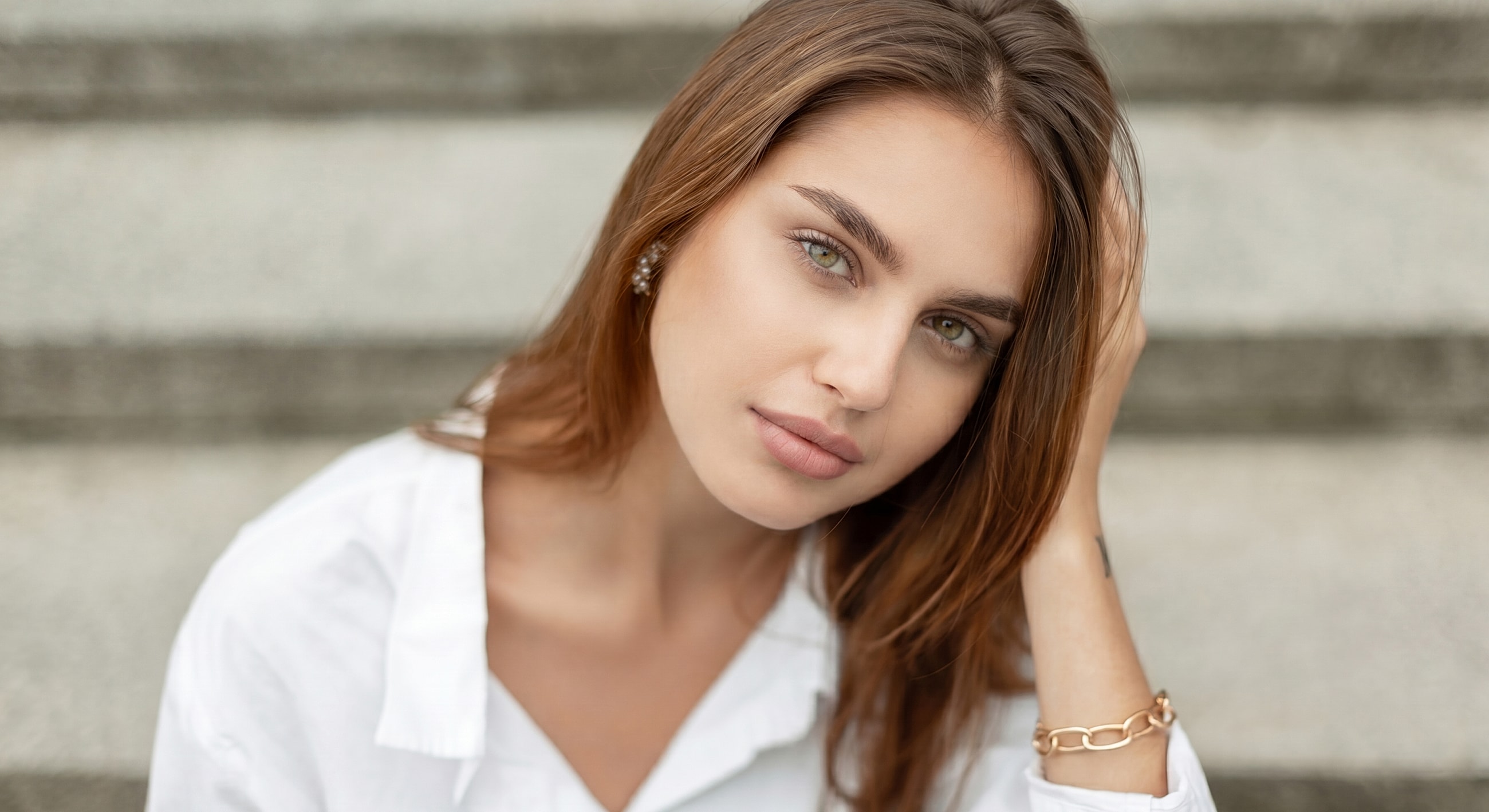 Young woman with long hair and subtle expression.