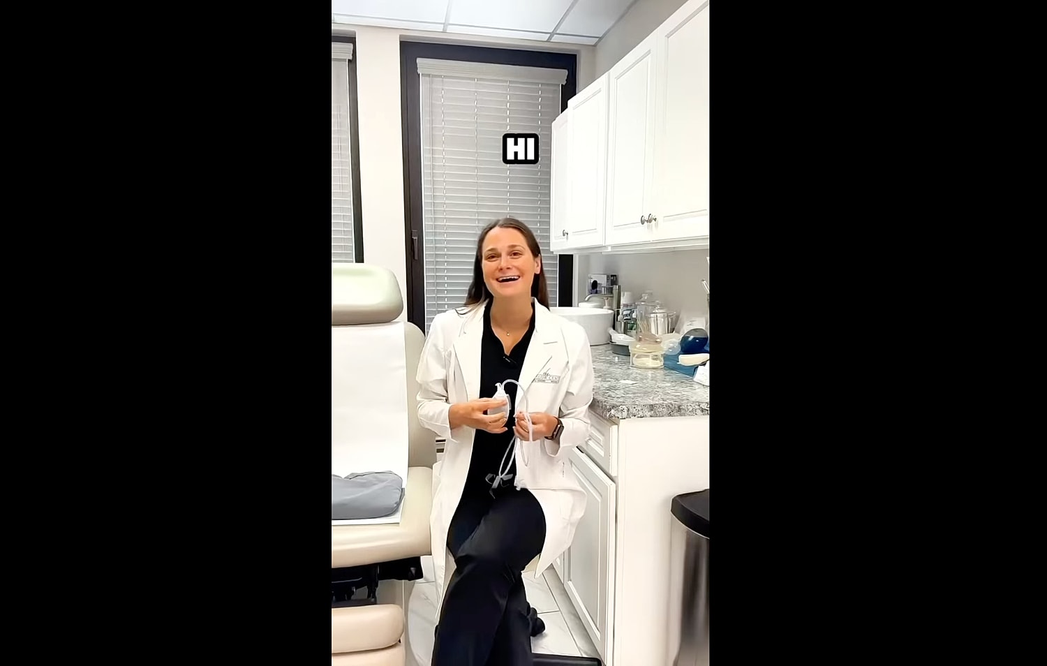 Person in a clinic greeting with a smile.