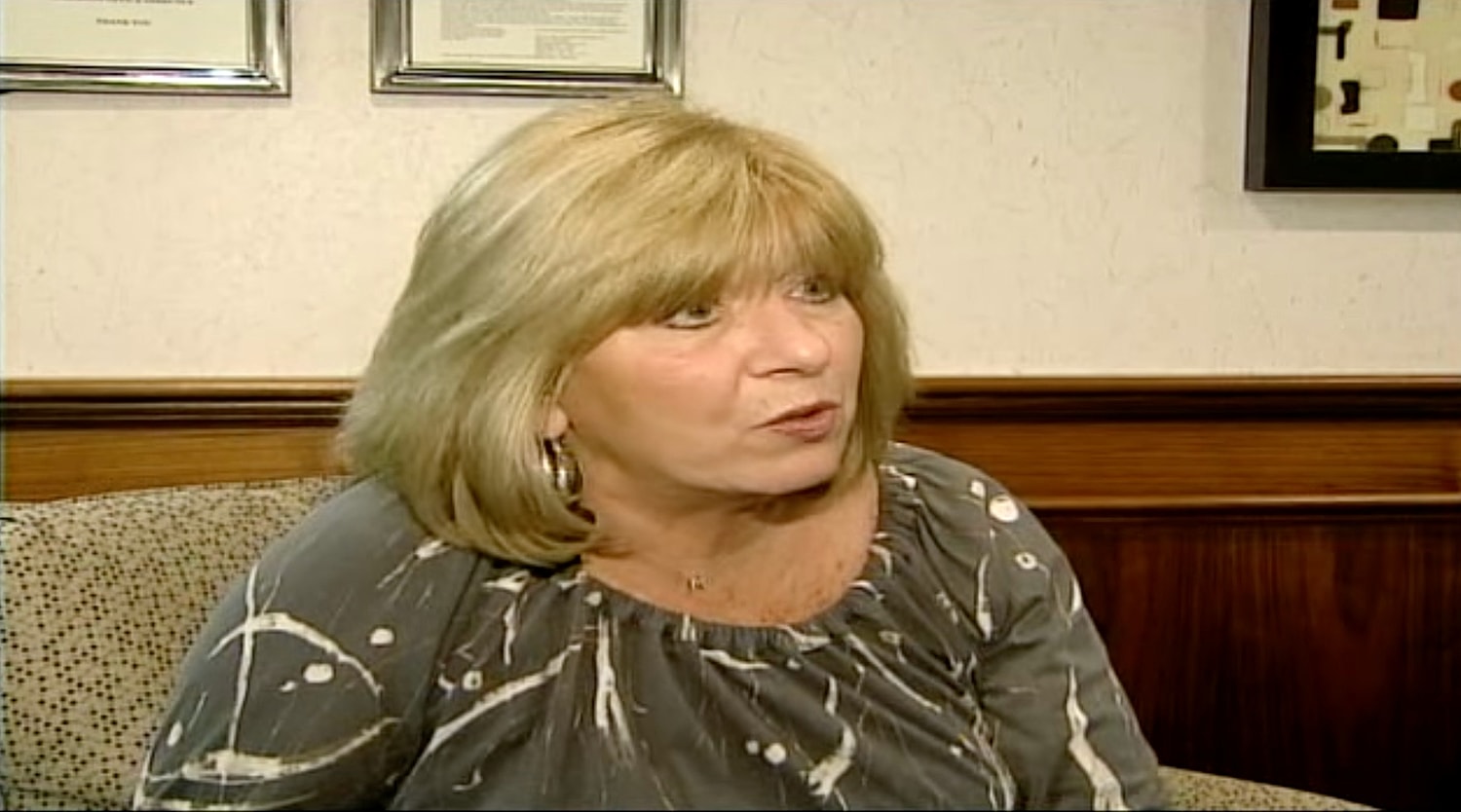 Woman speaking in a professional setting.